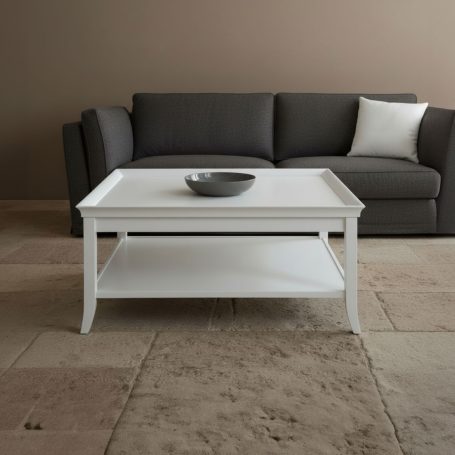 Weißer Couchtisch mit einer Schüssel, vor einem grauen Sofa in einem modernen Raum.